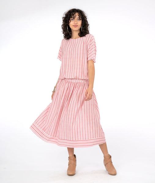 model in a red and white striped dress with an billowy top and a contrasting band at the bottom