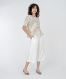 model in a white cropped pant with a yellow, white and grey striped top
