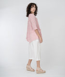 model in a red and white striped top with a white, wide leg cropped pant