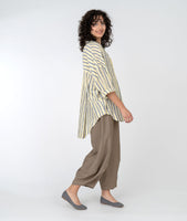 model in a wide leg brown pant with a striped top