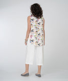 model in a cropped white pant and a floral print tank