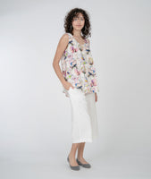 model in a cropped white pant and a floral print tank