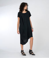 model in a black asymmetrical dress with a drape detail on one shoulder