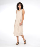 model in a sleeveless oatmeal color dress with tucks at the waist
