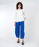model in a white blouse with a wide leg electric blue pant
