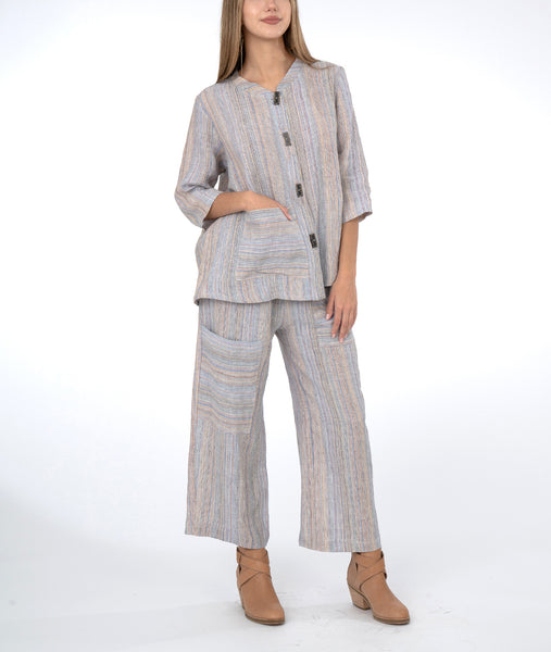 model in a pastel striped wide leg pant, with a matching jacket. 