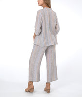 model in a pastel striped wide leg pant, with a matching jacket. 
