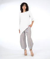 model in a striped pant with an asymmetrical white top