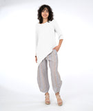 model in a striped pant with an asymmetrical white top
