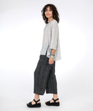 model in a black and white wide leg pant with a white and black matching top with a button and split detail