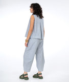 model in a white and blue pinstripe pant with a matching sleeveless top