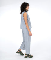 model in a white and blue pinstripe pant with a matching sleeveless top
