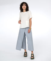 model in a white tee with a pinstripe wide leg pant