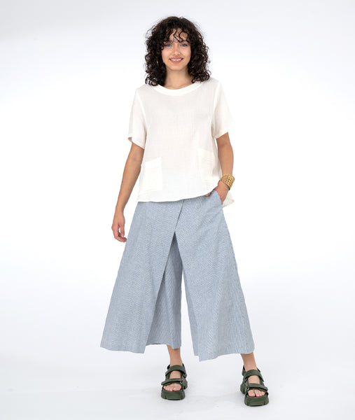 model in a white tee with a pinstripe wide leg pant