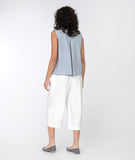 model in a sleeveless pinstriped button down top with a white wide leg cropped pant