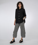 model in a black and white striped pant with a long button down blouse in black
