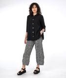 model in a wide leg black and white stripe pant with a long button down black blouse with 3/4 sleeves and a twin button detail